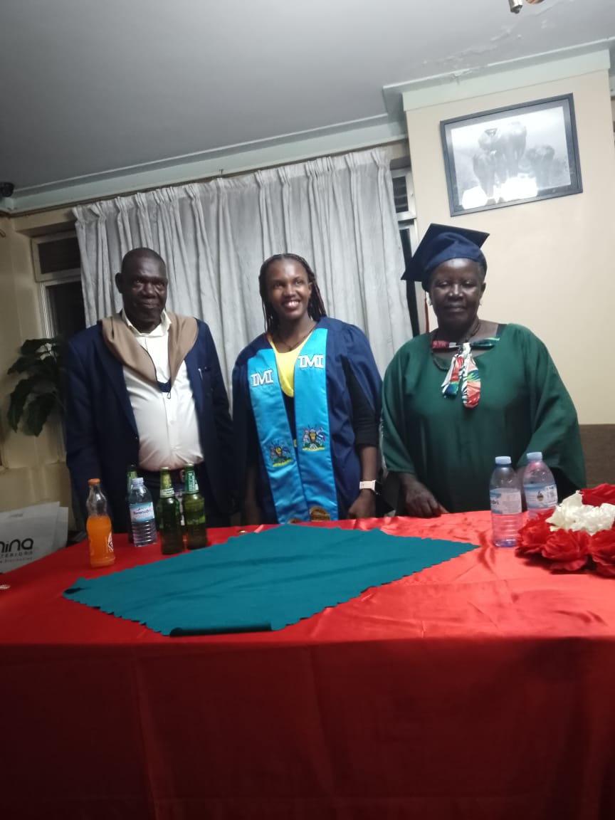 A graduate celebrating with family members