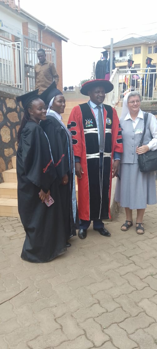 Graduates and academic leaders gathered after a graduation ceremony